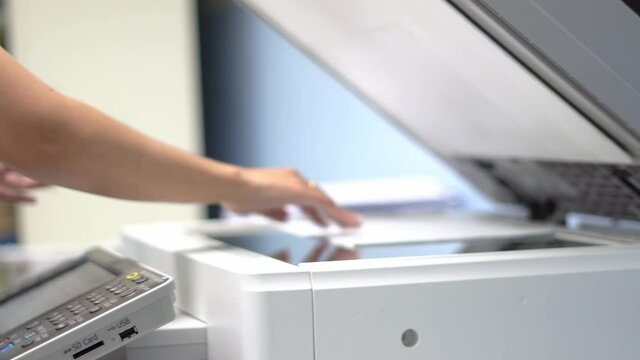 Female workers are working on documents by copying documents with a multifunction copier machine.