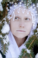 winter girl pale and white in the snow portrait