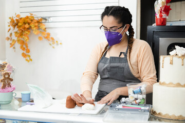 Young pastry chef working with mask - Hispanic pastry chef working with fondant - enterprising woman
