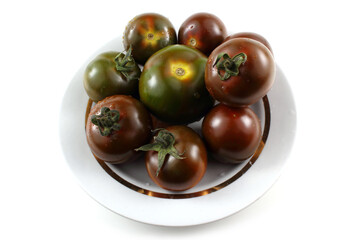 Brown tomatoes on dish