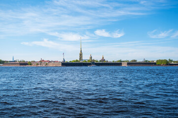 Fototapeta na wymiar Peter and Paul fortress in Saint-Petersburg, Russia. Petersburg architecture. Petersburg museums. Walls of fortress, spring blue sky, landscape, sunny day. Neva River.