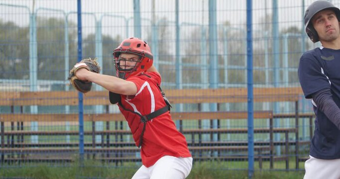 Baseball game, batter misses the ball, catcher teenage catches a fastball, training day.