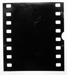 underexposed black single filmstrip isolated on white with dust and scratches. small film snip with...