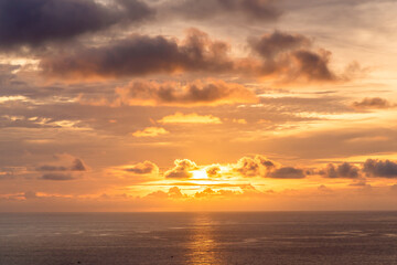 Aerial panorama view of gold color sunset at the ocean.