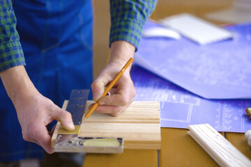 Engineer carpenter working on laptop and sketching project