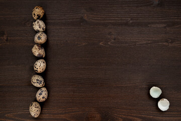 Obraz na płótnie Canvas Quail eggs on a dark wooden background. Delicious and healthy Breakfast, lifestyle, ingredients for cooking different dishes. Photo of food.