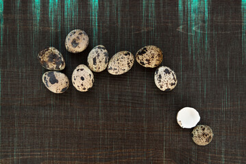 Obraz na płótnie Canvas Quail eggs on a dark wooden background. Delicious and healthy Breakfast, lifestyle, ingredients for cooking different dishes. Photo of food.