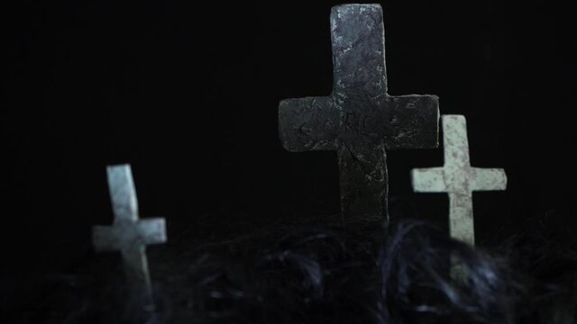Graveyard crosses on dark creepy background panning shot