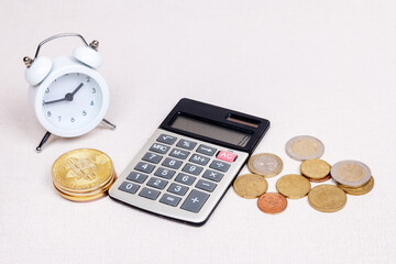 clock with bitcoin coin and calculator