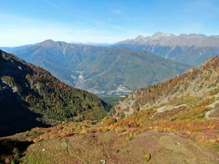 Aerial view panoramic landscape of mountains at sunset on the background of blue sky. Beautiful sunset landscape in the mountains