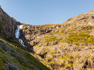 Fototapeta na wymiar Waterfall over Trollstigen mountain road, Norway