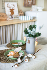 Table setting for christmas dinner, home made cookies . Chrismas decoration on the kitchien, wooden decor