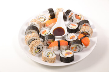 sushi and maski with soy sauce on white background