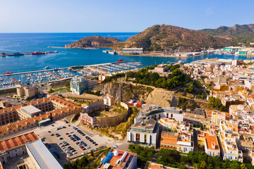 Fototapeta na wymiar Aerial view of cityscape and marina of Spanish city of Cartagena in sunny summer day, Region of Murcia