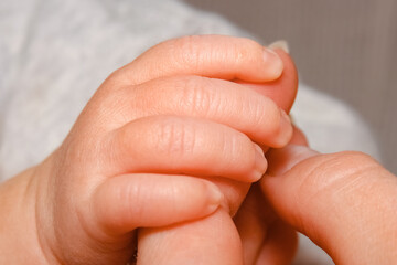 Happy baby hand and parent's background