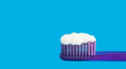 toothbrush with paste on a blue background