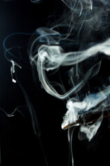 Heated soldering iron with smoke from the sting of burning rosin. Photo on a black background