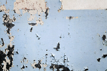 gray and blue painted abstract wall. Peeling paint of blue cement wall. Cracked flaking grey paint on wall.
