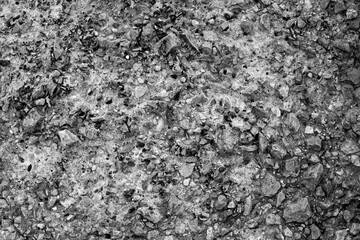 black and white texture of surface composed of concrete and stones