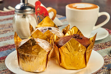 coffee and muffins on table in cafe close up