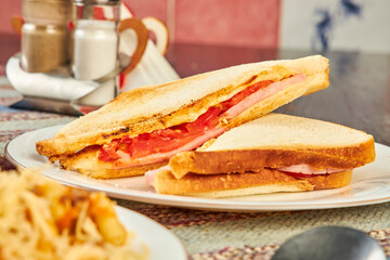 sandwiches with tomatoes and ham in a cafe close up