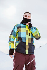 Fototapeta na wymiar Boy in coat on a snowy mountain