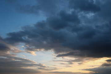 Naklejka na ściany i meble Beautiful sunset sky above clouds with dramatic light