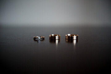wedding gold rings on a dark wooden table