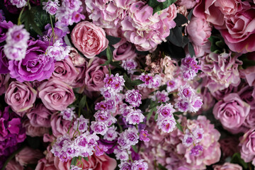 Fototapeta premium Closeup image of beautiful flowers wall background with amazing colorful roses. Top view