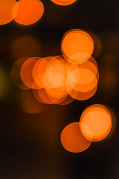 Portrait view of out of focus yellow, orange light bokeh wallpaper or background for texts, images and articles, blank space with blurred background.Large golden bokeh.