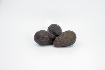 Three avocados on a white background.