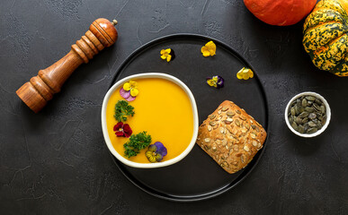 Bowl with seasonal pumpkin cream soup. Vegan recipe
