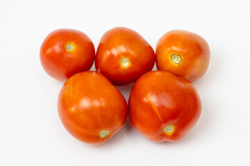 Beautiful fresh red tomatoes isolated on white background