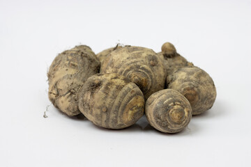Bunch of fresh organic jerusalem artichoke close up isolated on white background