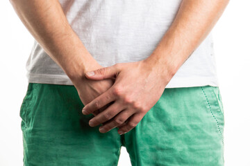 male sexual problems. the man's hands cover his groin
