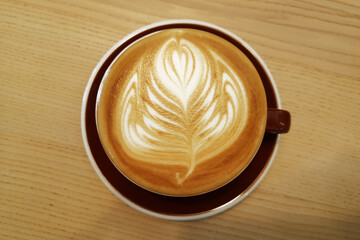 a cup of latte art coffee on wooden background                           