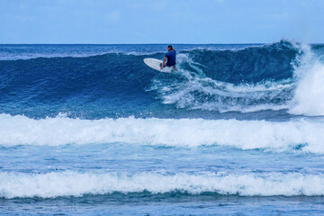 Surfer on perfect blue aquamarine wave, empty line up, perfect for surfing, clean water, Indian Ocean
