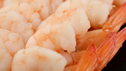 fresh shrimps close up on black plate