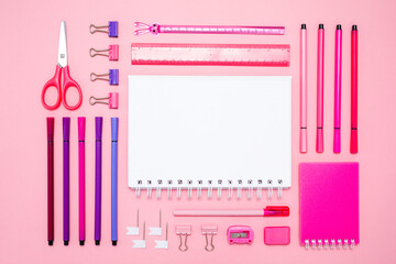 Pink notepad, pencil and marker on pink background. Flat lay. Concept office and back to school