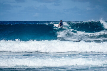 Surfer on perfect blue aquamarine wave, empty line up, perfect for surfing, clean water, Indian Ocean