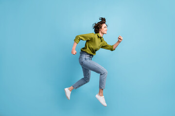 Fototapeta na wymiar Photo portrait side view of woman running jumping up isolated on pastel light blue colored background