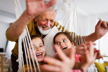 Happy grandparent having fun times with kid at home