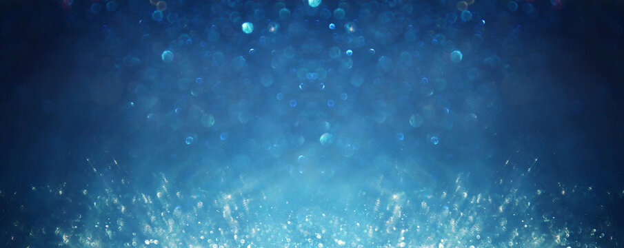 background of abstract glitter lights. silver, blue and black. de focused
