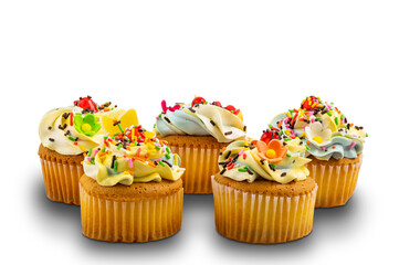 Group of vanilla cupcake with vanilla butter cream frosting decorated with multicolored rainbow sprinkles on white background with clipping path.