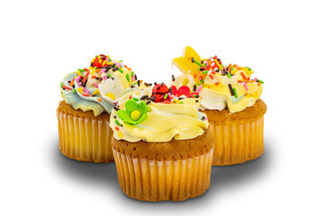 Vanilla cupcakes garnished with colorful vanilla butter cream frosting and multicolored sprinkles on white background with clipping path