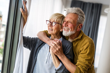 Happy senior couple in love hugging and bonding with true emotions