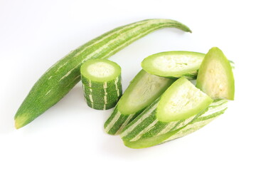 Snake gourd or Zucchini snake. Close up of green fresh vegetables on white background