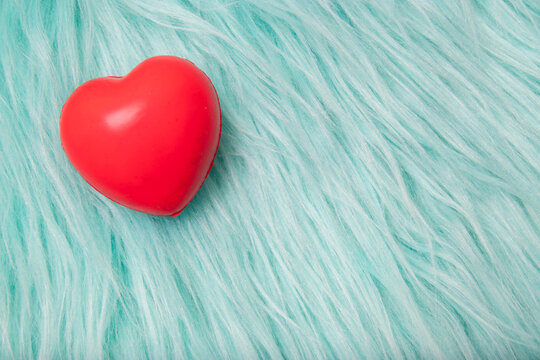 The red Heart shapes on abstract turquoise fur