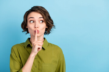 Photo portrait of girl keeping secret put finger near lips showing sign to be silent looking at...