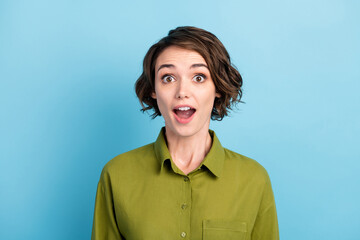 Obraz na płótnie Canvas Photo portrait of surprised amazed shocked young woman wearing clothes starring with opened mouth isolated on blue color background